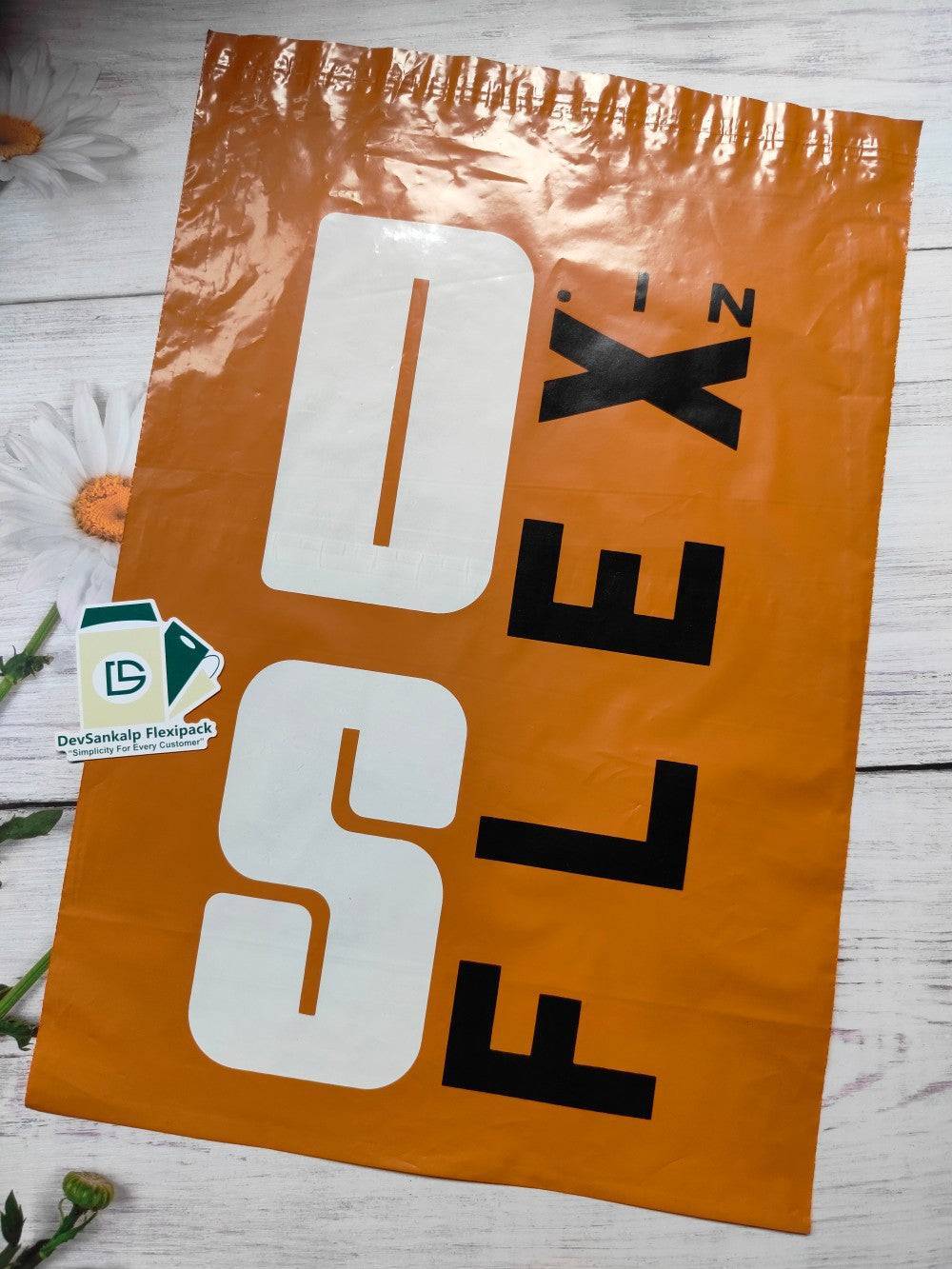 Multicolor printed orange courier bag with POD, featuring bold black and white branding. Durable poly mailer for secure shipping and brand visibility.