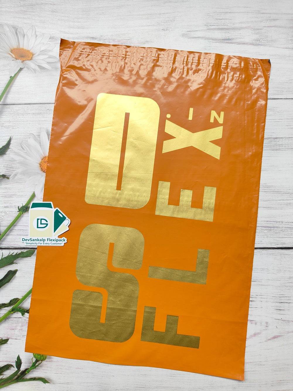 Customised printed burnt orange courier bag with POD, featuring bold gold branding. Durable poly mailer for secure shipping and brand visibility.
