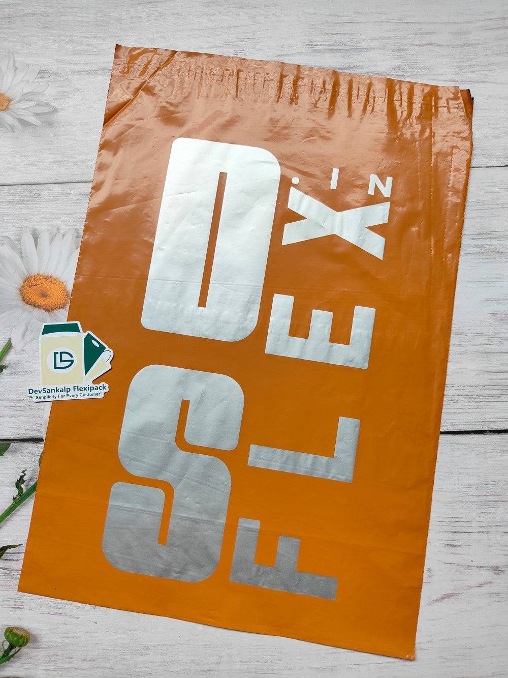 Custom branded orange courier bag with POD, featuring a bold silver logo. Durable poly mailer for secure shipping and brand visibility.